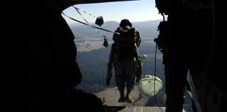 Paratrooper jumping from aircraft
