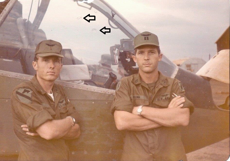 CWO Dan Green and CPT Bill Reeder in front of bullit riddled cockpit post battle